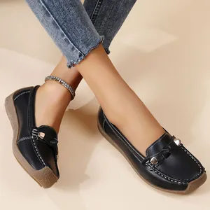 Detail of comfortable black leather slip-on loafers for women with soft rubber sole