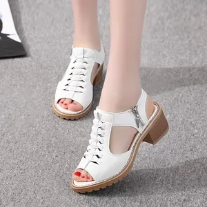 Detail of white Roman sandals with hollow design and block heel