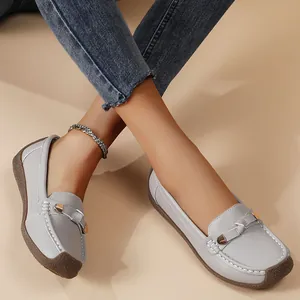 Detail view of light grey women's loafers with metal buckle and soft textured sole
