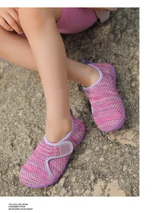 Close-up detail of breathable purple mesh water shoes for kids on outdoor sandy ground