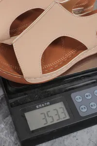 Detail shot of a lightweight wedge sandal on an electronic scale weighing 353.3g