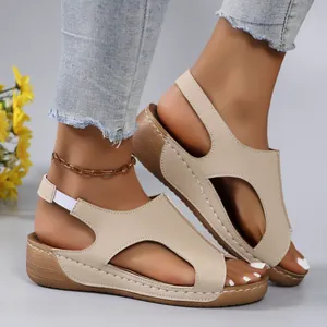 Detailed side view of beige wedge sandals with stylish cut-outs and soft thick soles.