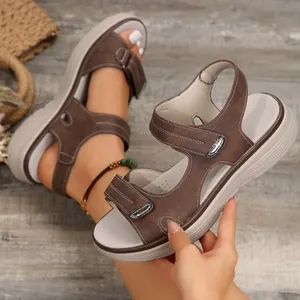 Detailansicht brauner Sport-Keilsandaletten mit Klettverschluss und dicker weißer Sohle