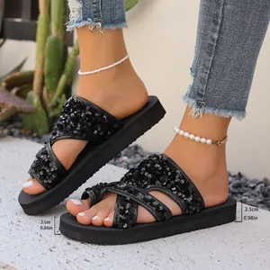 Gros plan sur des sandales compensées à paillettes noires avec semelle de 2,5 cm
