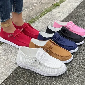 Variety of colorful corduroy slip-on loafers for women in outdoor setting