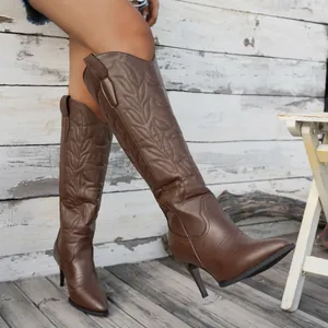 Brown knee-high boots with embroidery, pointed toe and stiletto heels.