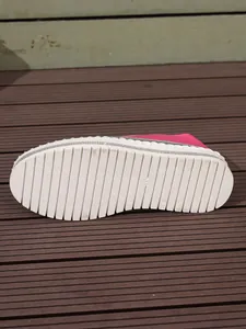 Detail view of white platform shoe sole with anti-slip ridges and rhinestone trim