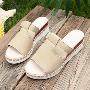 Stylish beige wedge platform sandals for women displayed on a rustic wooden background