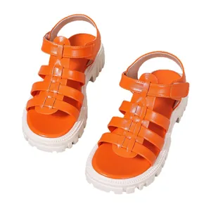 Vibrant orange Roman sandals with chunky white platform soles and open toe design.