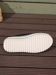 Detailed view of stylish women's black platform loafer showing the white ribbed sole