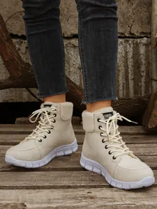 Close-up van beige winterlaarzen met een pluche kraag en dikke platformzolen