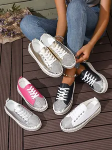Detailed shot of platform rhinestone sneakers in multiple colors on a wooden deck