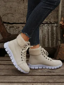 Detail van beige dames winterlaarzen met warme voering van imitatiebont en zool