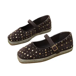Dark brown Mary Jane ballet flats with gold rivet accents and braided straw midsoles
