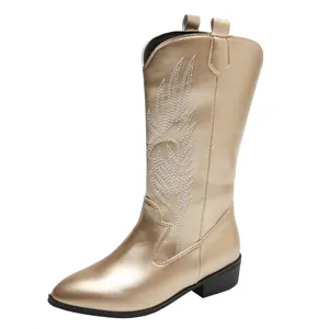 Metallic champagne gold cowboy boots with detailed white embroidery and a pointed toe