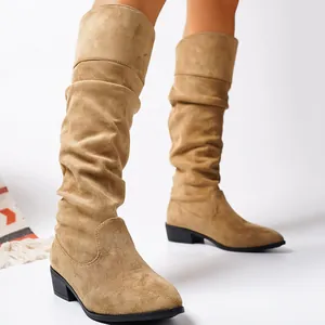 Side view detail of camel suede slouchy knee-high boots with pointed toe and mid block heel