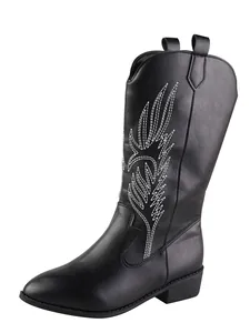 Close-up detail of black embroidered women's cowboy boots with pointed toe and square heel