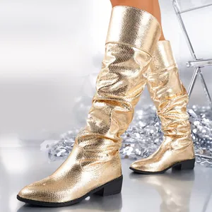 Detailed shot of stylish golden metallic snakeskin slouched knee-high fashion boots