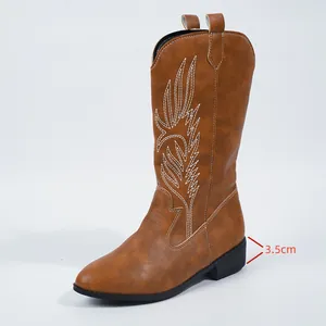 Close-up detail showing the 3.5cm low block heel on these brown embroidered cowboy boots
