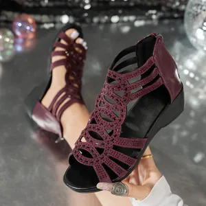 Detailed macro view of burgundy hollow-out Roman sandals with sparkling rhinestone accents