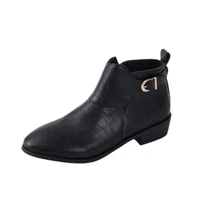 Close-up of black croc-embossed ankle boot with elegant gold buckle detail