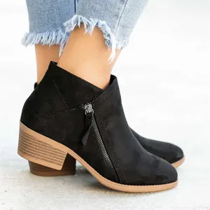 Detailed side view of women's black suede ankle boots with chunky heel and side zipper