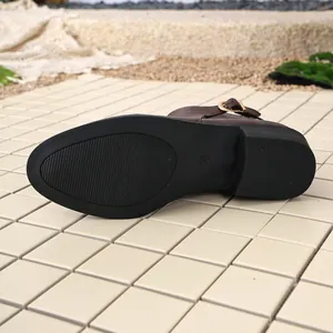 Close-up of brown women's knight boot sole showing size 38 and anti-slip texture.