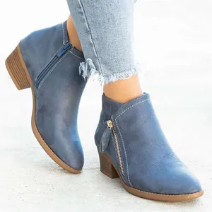 Gros plan détaillé de bottines en daim bleu élégantes avec fermeture éclair et petit talon
