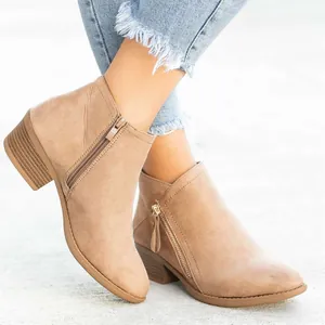 Close-up detail of women's khaki faux suede ankle boots with chunky low heel and side zipper