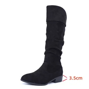 Detailed side view showing the 3.5cm block heel on black slouchy suede knee-high boots