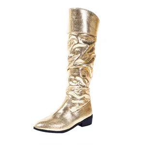 Metallic gold slouchy knee-high boots with pointed toe and snake skin texture detail