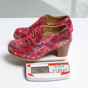 Detail view demonstrating the 482.4g weight of these colorful patterned chunky heel pumps.