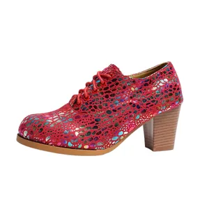 Detailed side view of a red chunky heel shoe with colorful spotted patterns and lace-up
