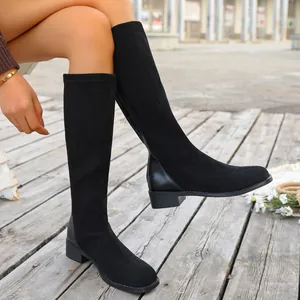 Detailed view of women's black square-toe knee-high boots with stylish low block heels