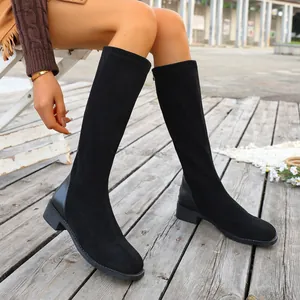 Detail view of black suede knee-high boots with square toe and low block heel design