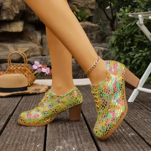 Macro view of colorful metallic scale pattern on these lace-up chunky heel pumps.
