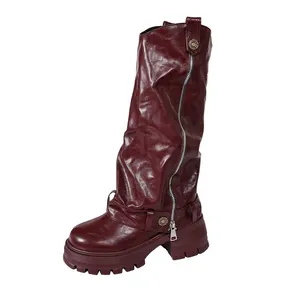 Side profile of burgundy slouchy platform tall boots with zipper detail