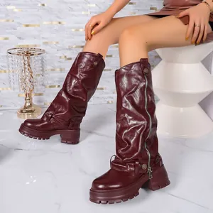 Detailed view of burgundy slouchy platform knee-high boots featuring side zipper and buckle