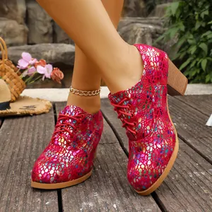 Detailed view of vibrant pink lace-up pumps with metallic scale pattern and chunky block heel