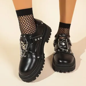 Gothic style black platform shoes with silver skull ornament and metal chain detail