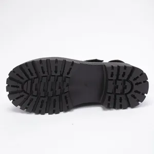 Detailed view of the chunky lugged rubber outsole on black punk style leather shoe