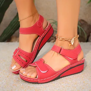 Close-up view of red retro women platform wedge sandals with velcro straps and stitching