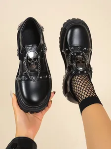 Gothic subculture platform shoes featuring silver skull hardware and metal chains