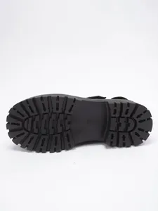 Close-up detail of the durable black chunky lug sole on a punk style shoe