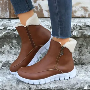 Detail shot of brown winter ankle boots with cozy fleece lining and side zipper.