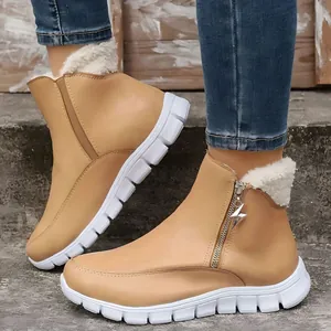 Detailed view of camel winter ankle boots with white fleece lining and star zipper pull