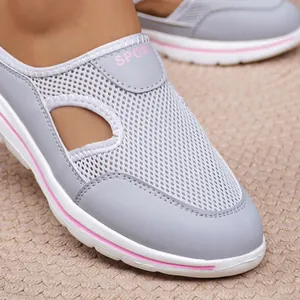 Close-up of breathable grey mesh slip-on shoe with pink trim and thick white sole