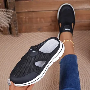 Detail view of black breathable mesh platform mules with white soles and SPORT logo