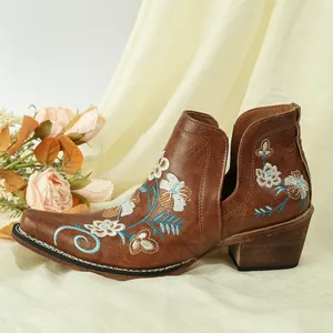 Detailed side view of brown embroidered Western boots with elegant floral patterns