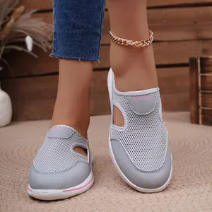 Detailed shot of grey mesh mules on foot with breathable cut-out design and thick sole